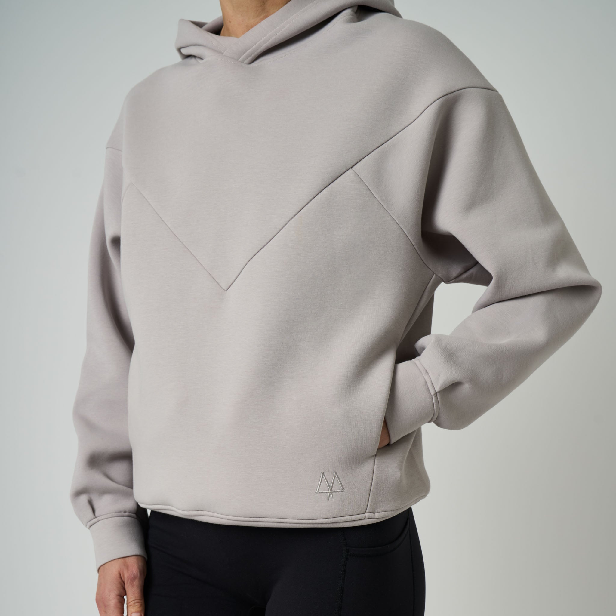 Light gray hoodie worn by a person on a plain background