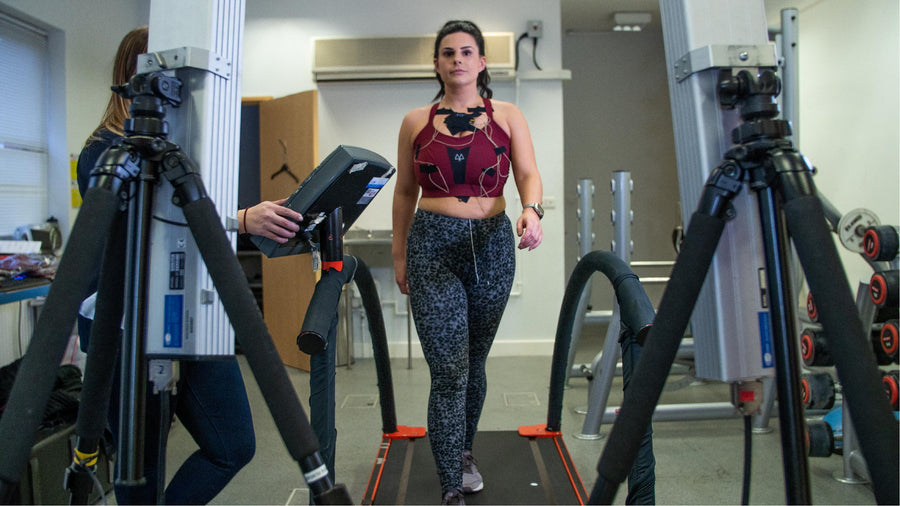 Participant running on a treadmill while 3D cameras track motion